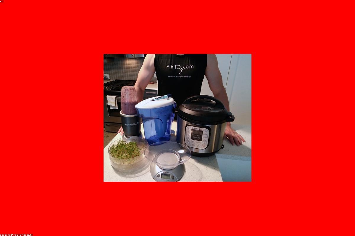 Extracteur de jus entouré de fruits frais sur un plan de travail